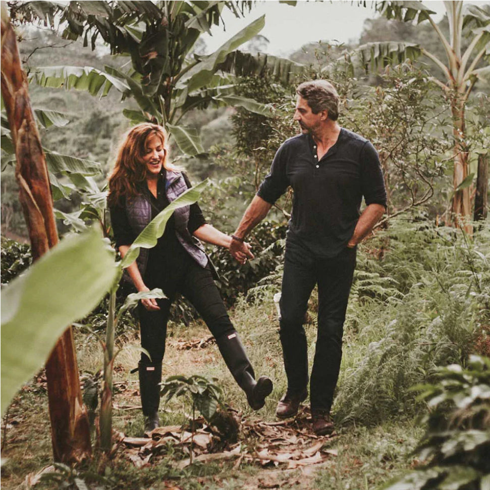 Founders Andrew and amber walking through a coffee farm