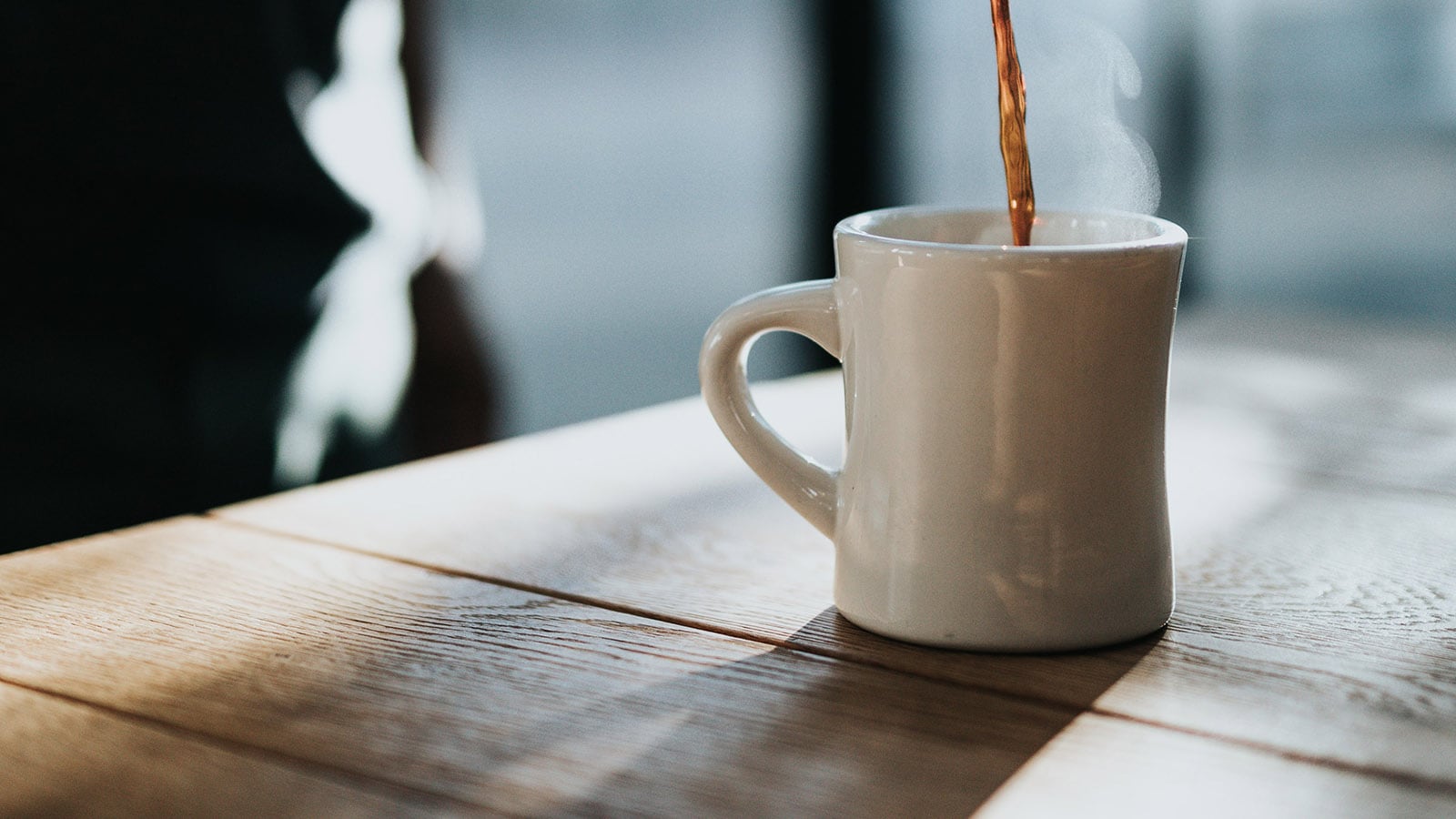 Coffee pouring into a white mug