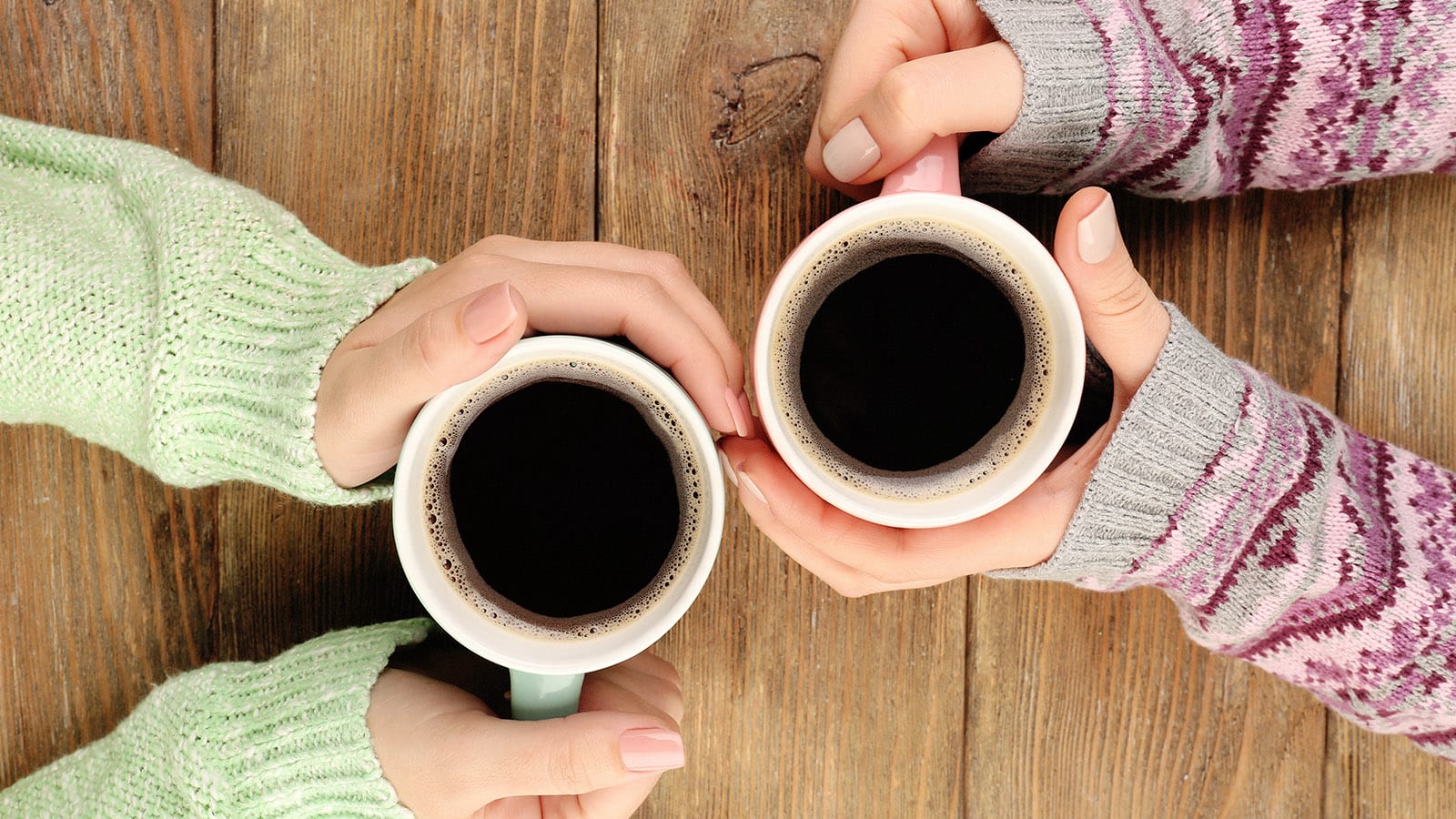 Women drinking black coffee together