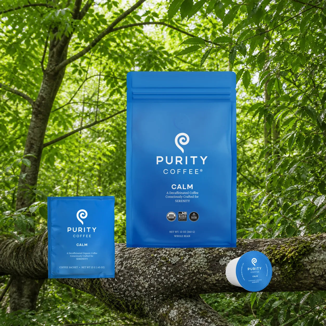 Purity Coffee CALM decaf coffee products in a green outdoor setting